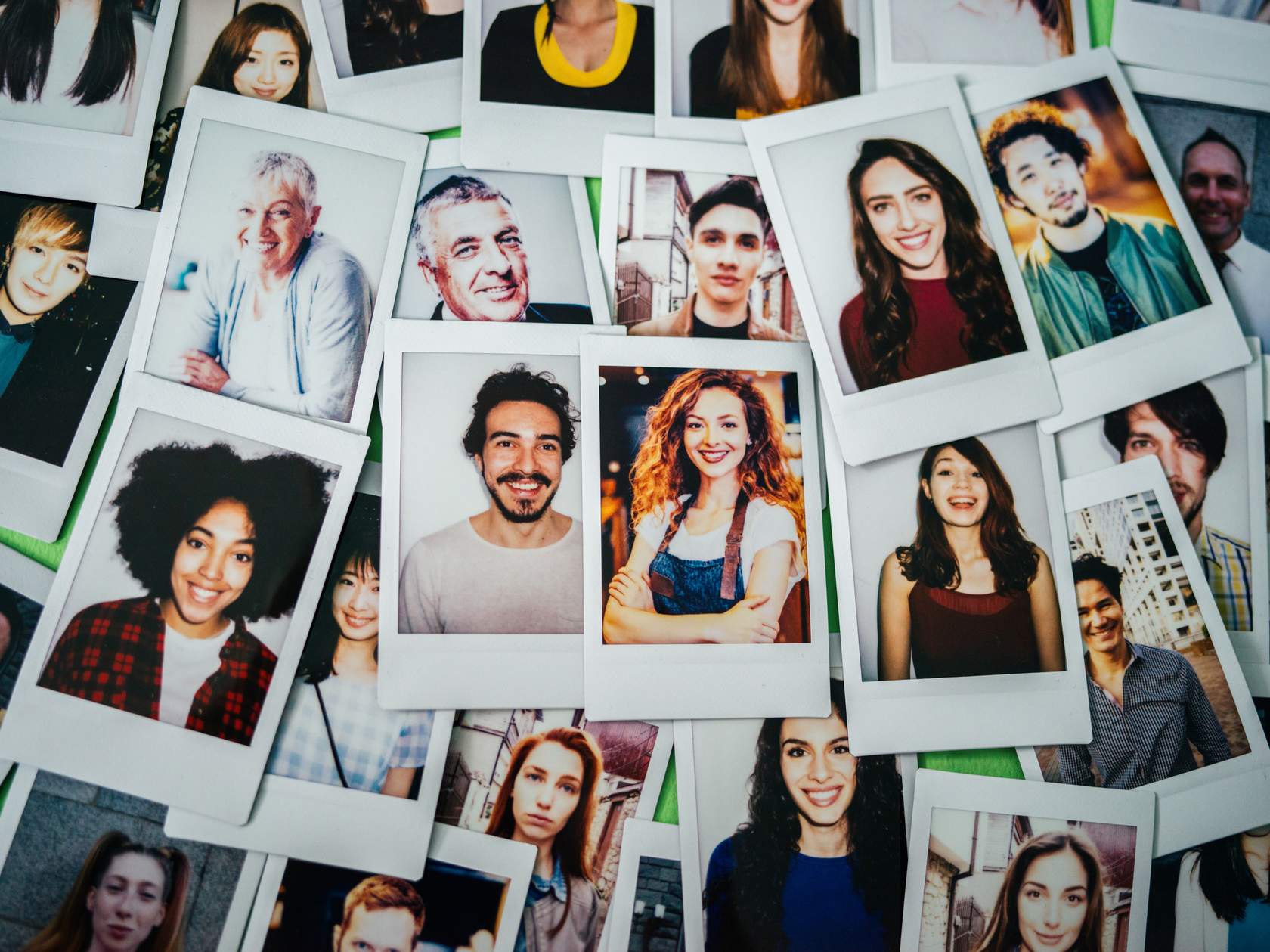 Montage of polaroid pictures of faces of men and women