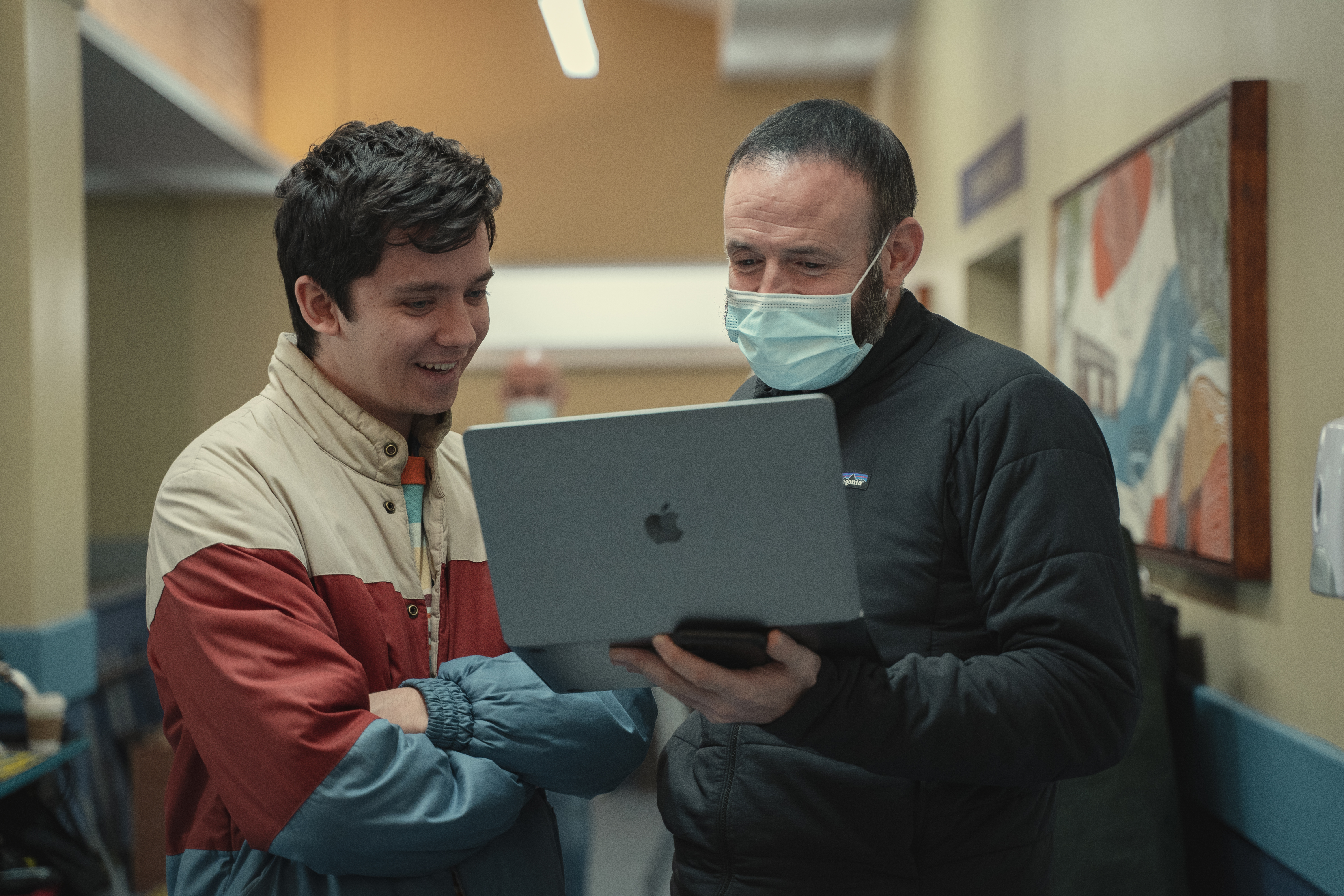 A director and an actor look at a laptop screen together