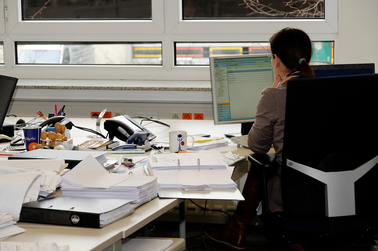 assistant sitting by an office desk