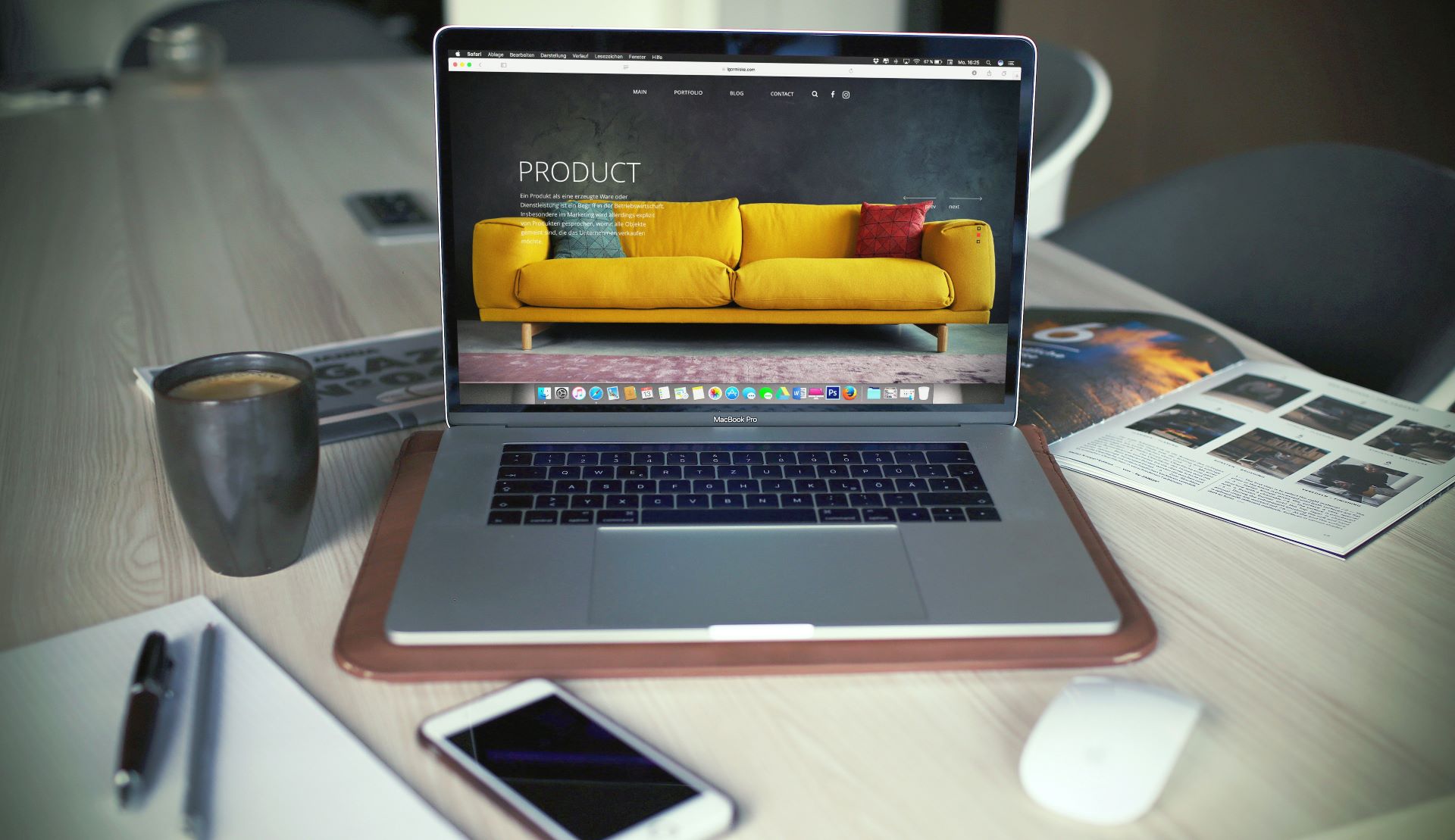 A laptop on a work desk displaying a web page with a bright yellow sofa indicating online shopping