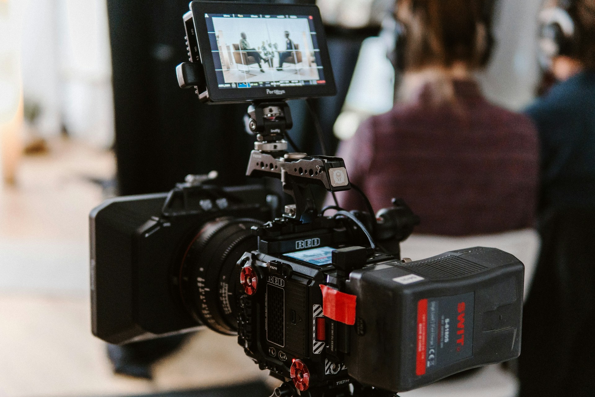 A close up of a camera recording a talk show