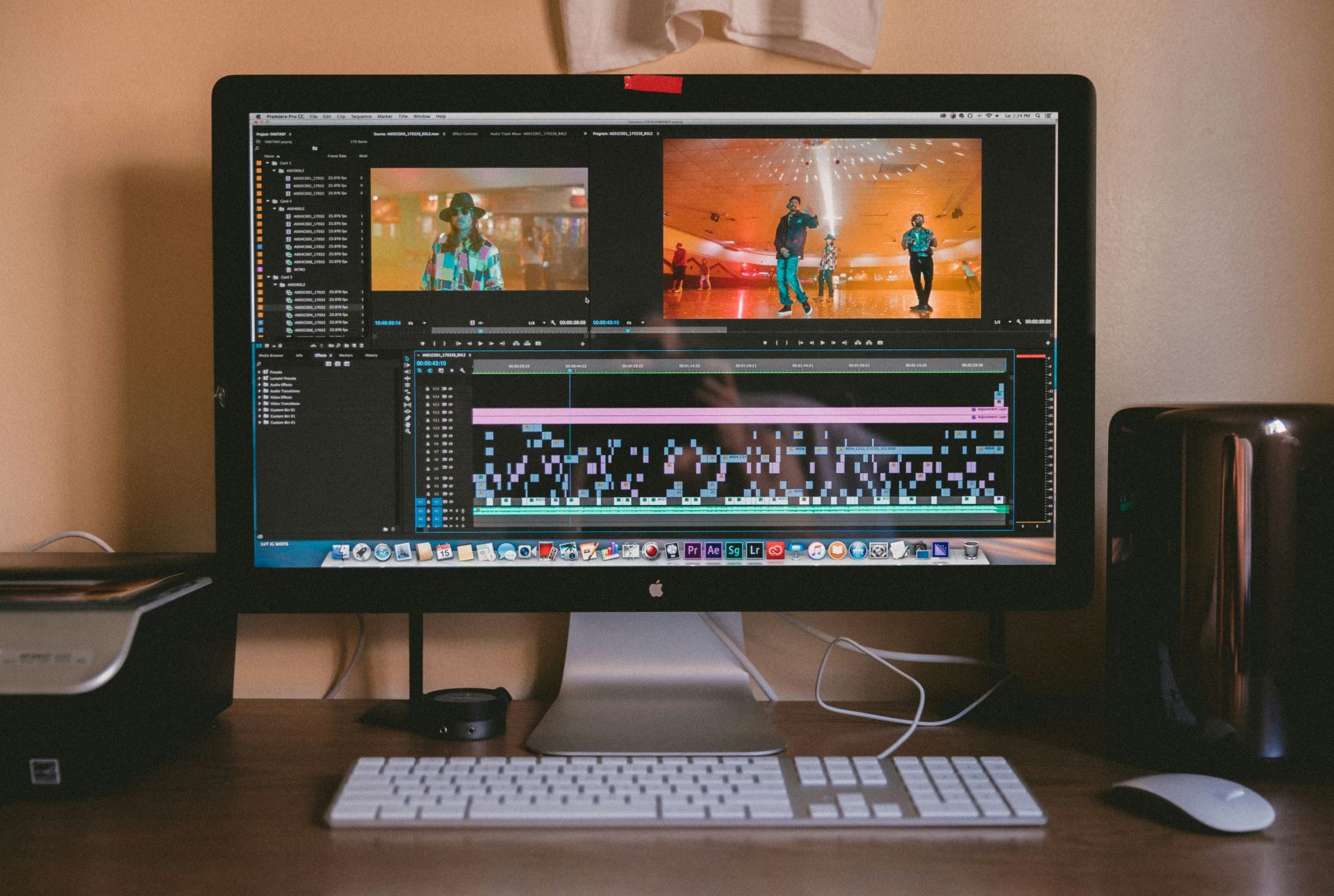 A MacBook computer is sat on a table. The screen is opened a page of editing software.