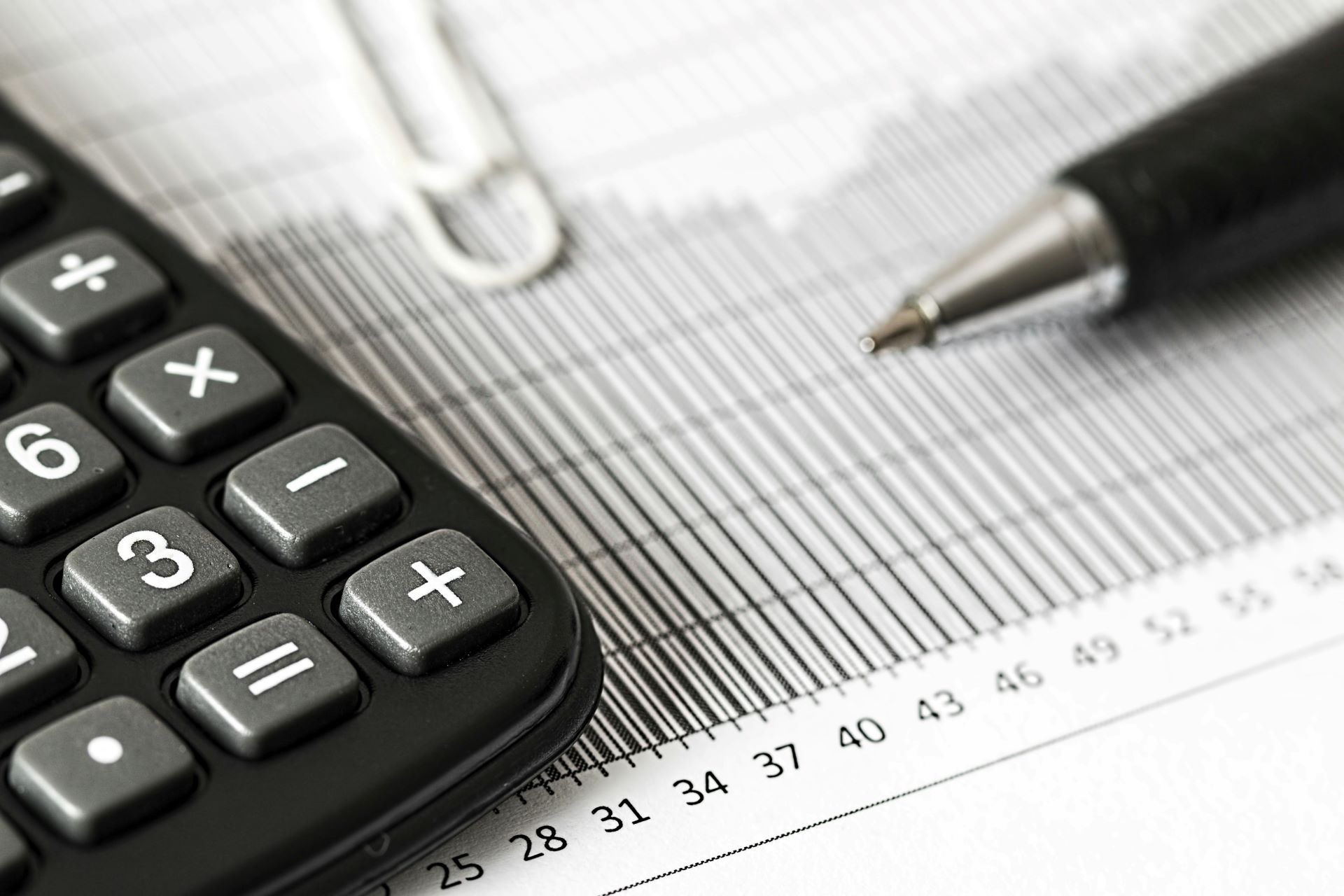 Close up of  a calculator, pen and other stationary