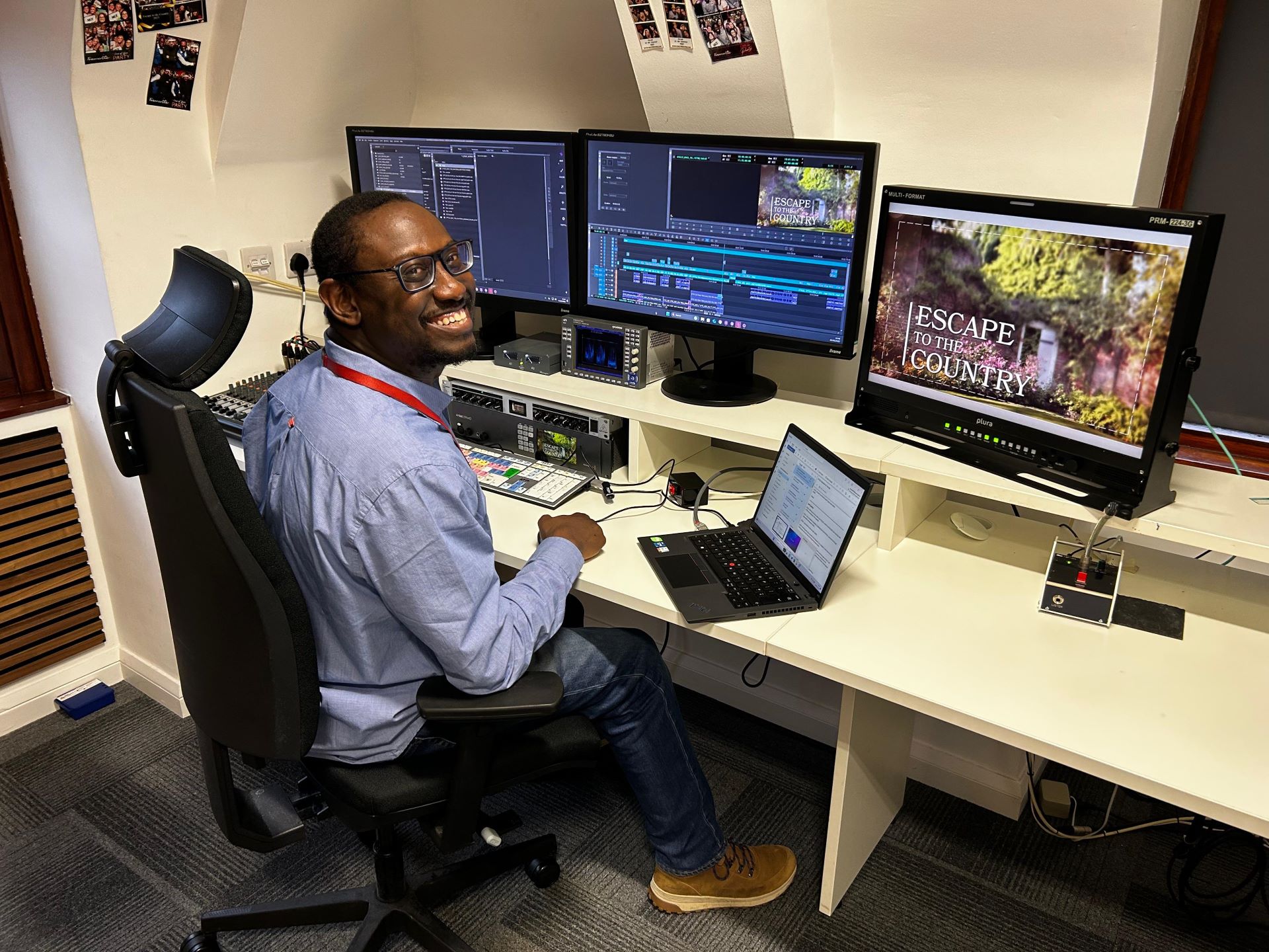 Online editor Jay Francis sits at his workstation in front of computer screens