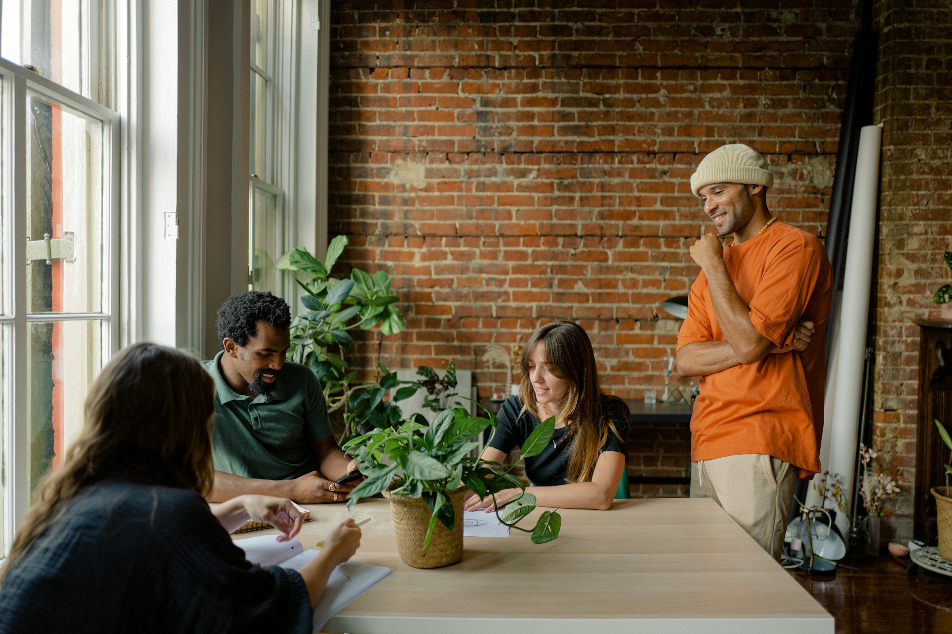 A group of people sit around a table having a discussion 